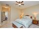 Bedroom featuring a ceiling fan, bedside tables with lamps, and natural light at 11607 Meetinghouse Dr, Cornelius, NC 28031