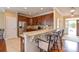 Well-equipped kitchen with a breakfast bar, granite countertops, stainless steel appliances, and tile flooring at 11607 Meetinghouse Dr, Cornelius, NC 28031