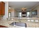 Open-concept kitchen showcasing granite countertops with breakfast bar overlooking the living room and fireplace at 11607 Meetinghouse Dr, Cornelius, NC 28031