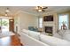Cozy living room with a fireplace, ceiling fan, hardwood floors, and neutral walls at 11607 Meetinghouse Dr, Cornelius, NC 28031