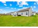 Expansive backyard featuring a well-manicured lawn with a patio seating area and view of the home at 130 Slalom St, Statesville, NC 28677