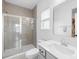 Well-lit bathroom featuring a glass-enclosed shower and modern vanity with gray cabinets at 130 Slalom St, Statesville, NC 28677