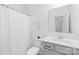 Neutral bathroom with a shower curtain, standard size toilet and vanity with gray cabinets at 130 Slalom St, Statesville, NC 28677
