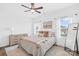 Cozy bedroom featuring a ceiling fan, neutral walls, and natural light from the double windows at 130 Slalom St, Statesville, NC 28677