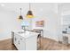 Bright kitchen features an island with a sink, white countertops, and stainless steel appliances at 130 Slalom St, Statesville, NC 28677