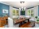Elegant dining room features a wooden table with seating, bright windows, and stylish light fixture at 141 Eastover Se Dr, Concord, NC 28025