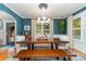 Elegant dining room features a wooden table with seating, bright windows, and stylish light fixture at 141 Eastover Se Dr, Concord, NC 28025