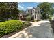 Stunning two-story home with a long driveway, lush landscaping, and classic architectural details at 141 Eastover Se Dr, Concord, NC 28025