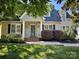 Charming home with a beautiful teal door and landscaped front yard, and inviting curb appeal at 141 Eastover Se Dr, Concord, NC 28025