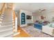 Inviting living room with hardwood floors, neutral walls, lots of windows and staircase at 141 Eastover Se Dr, Concord, NC 28025