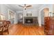 Inviting living room with hardwood floors, a decorative fireplace, and open archways at 141 Eastover Se Dr, Concord, NC 28025