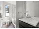 Modern bathroom featuring a sleek vanity, a shower-over-tub with glass screen, and a large window at 1620 S Tryon St, Charlotte, NC 28203