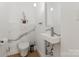 Modern half-bathroom with a marble accent wall, sleek fixtures, and a minimalist design at 1620 S Tryon St, Charlotte, NC 28203