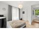Bright bedroom with a large window, stylish light fixture, and neutral decor offers a serene and inviting atmosphere at 1620 S Tryon St, Charlotte, NC 28203