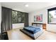 Spacious bedroom with large windows, hardwood floors, and modern decor offers a comfortable and stylish living space at 1620 S Tryon St, Charlotte, NC 28203