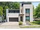 Contemporary home design featuring a two-car garage, stone accents, and professionally landscaped front yard at 1620 S Tryon St, Charlotte, NC 28203