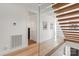 Bright hallway with hardwood floors, glass railing, and white walls, showcasing modern design and an open layout at 1620 S Tryon St, Charlotte, NC 28203