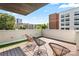 Relaxing rooftop deck with artificial turf, three chairs and views of city skyline at 1620 S Tryon St, Charlotte, NC 28203