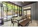 Bright sunroom with views of fenced backyard, and a dining table with long bench at 1620 S Tryon St, Charlotte, NC 28203