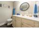 Bathroom with a single sink vanity, decorative mirror, and toilet, all in a well-lit space at 1804 Fairlawn Ct, Rock Hill, SC 29732
