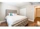 Comfortable bedroom with a tufted headboard bed, wood floors, and a closet for storage at 1804 Fairlawn Ct, Rock Hill, SC 29732