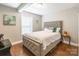 Cozy bedroom featuring a tufted headboard bed, wood floors, and soft natural light at 1804 Fairlawn Ct, Rock Hill, SC 29732