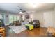 Open living room featuring hardwood floors, large windows, and comfortable seating at 1804 Fairlawn Ct, Rock Hill, SC 29732