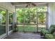 Relaxing screened porch with wooden flooring, a ceiling fan, and green foliage views at 1804 Fairlawn Ct, Rock Hill, SC 29732