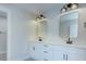 This bathroom has double sinks, gold trimmed mirrors and white cabinets at 2000 Plainfield Dr, Bessemer City, NC 28016