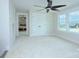 This carpeted bedroom has many windows, a closet and ceiling fan at 2000 Plainfield Dr, Bessemer City, NC 28016
