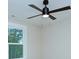 This ceiling fan is mounted on a ceiling next to a window at 2000 Plainfield Dr, Bessemer City, NC 28016