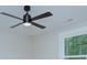 Close-up of a modern ceiling fan with lights in a room with natural lighting from the window at 2000 Plainfield Dr, Bessemer City, NC 28016