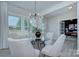 Open dining room with seating for 4, glass table, modern chandelier and neutral colors at 2000 Plainfield Dr, Bessemer City, NC 28016