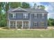 Charming two-story home with gray siding, shutters, stone accents and a well-manicured lawn at 2000 Plainfield Dr, Bessemer City, NC 28016