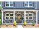 Inviting front porch with stone accents, decorative plants, and a welcoming entryway, accentuating the home's curb appeal at 2000 Plainfield Dr, Bessemer City, NC 28016