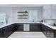 Well-designed kitchen featuring sleek black cabinets, quartz countertops, stainless steel appliances, and ample natural light at 2000 Plainfield Dr, Bessemer City, NC 28016