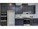 Stylish kitchen showcasing black cabinets with gold hardware and stainless steel appliances for a modern, sophisticated look at 2000 Plainfield Dr, Bessemer City, NC 28016