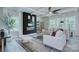 Living room with large windows, fireplace with modern art and neutral paint at 2000 Plainfield Dr, Bessemer City, NC 28016