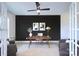 Open concept office space with built-in desk, lots of natural light, modern ceiling fan, and neutral paint at 2000 Plainfield Dr, Bessemer City, NC 28016