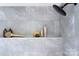 This shower has gray tiling and a built in shelf with assorted soaps and lotions at 2000 Plainfield Dr, Bessemer City, NC 28016