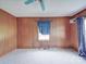 Bedroom featuring wood paneling, natural light, and neutral carpet at 201 Robinson Rd, Gastonia, NC 28056