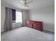 Bedroom featuring a dresser, window with curtain and carpet at 201 Robinson Rd, Gastonia, NC 28056