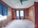 Bedroom featuring wood paneling, large windows, and neutral carpet at 201 Robinson Rd, Gastonia, NC 28056