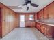 Kitchen with wood cabinets, tile floors, and ample natural light from a window at 201 Robinson Rd, Gastonia, NC 28056
