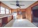 Simple kitchen featuring wood cabinets, tile floors, and an adjacent eating area at 201 Robinson Rd, Gastonia, NC 28056