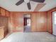 Living room featuring wood paneling, ceiling fan and tile floor at 201 Robinson Rd, Gastonia, NC 28056