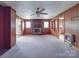 Living room boasting a classic brick fireplace, carpeted floors, and wood-paneled walls at 201 Robinson Rd, Gastonia, NC 28056