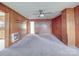 Living room featuring wood paneling, ceiling fan and carpet at 201 Robinson Rd, Gastonia, NC 28056