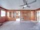 This living room features wood-paneled walls, carpeted floors, and an open layout at 201 Robinson Rd, Gastonia, NC 28056