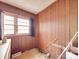 Room featuring wood paneling, window with curtain and tile floor at 201 Robinson Rd, Gastonia, NC 28056
